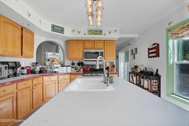 a kitchen with refrigerator cabinets and large window