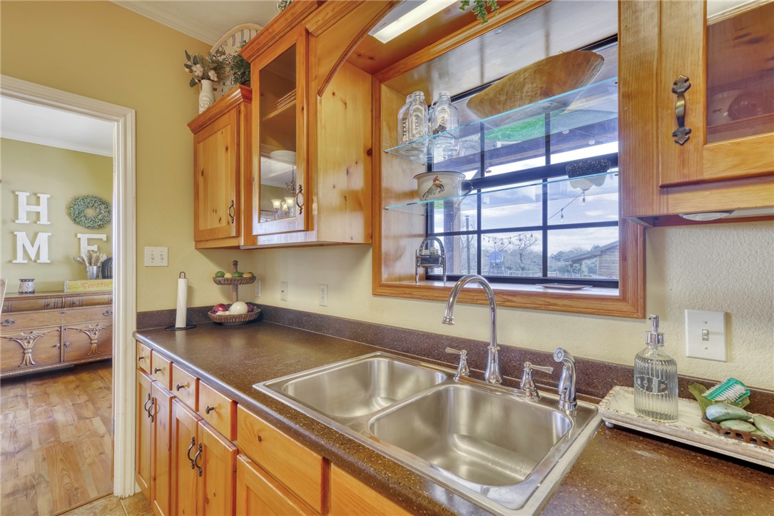 4404 County Road 151 Centerville, TX 75833 - Photo 16 of 48 a kitchen with a sink cabinets and a wooden floor