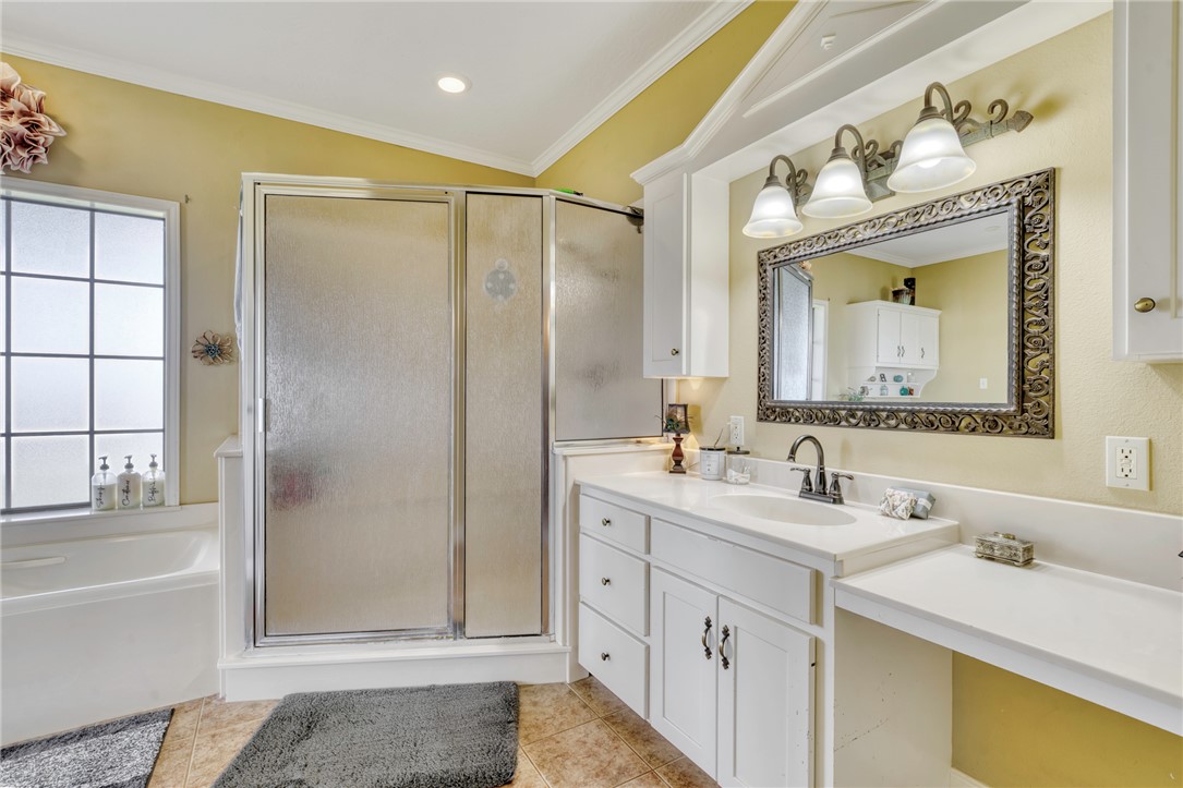 4404 County Road 151 Centerville, TX 75833 - Photo 20 of 48 a bathroom with a double vanity sink mirror and bathtub