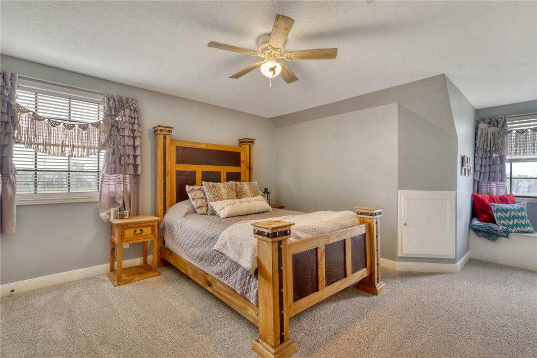 4404 County Road 151 Centerville, TX 75833 - Photo 22 of 48 a bedroom with a bed and a ceiling fan