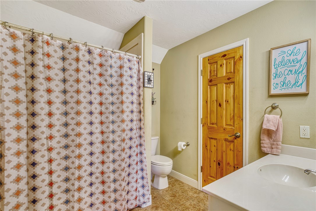 4404 County Road 151 Centerville, TX 75833 - Photo 23 of 48 a bathroom with a granite countertop sink toilet and shower