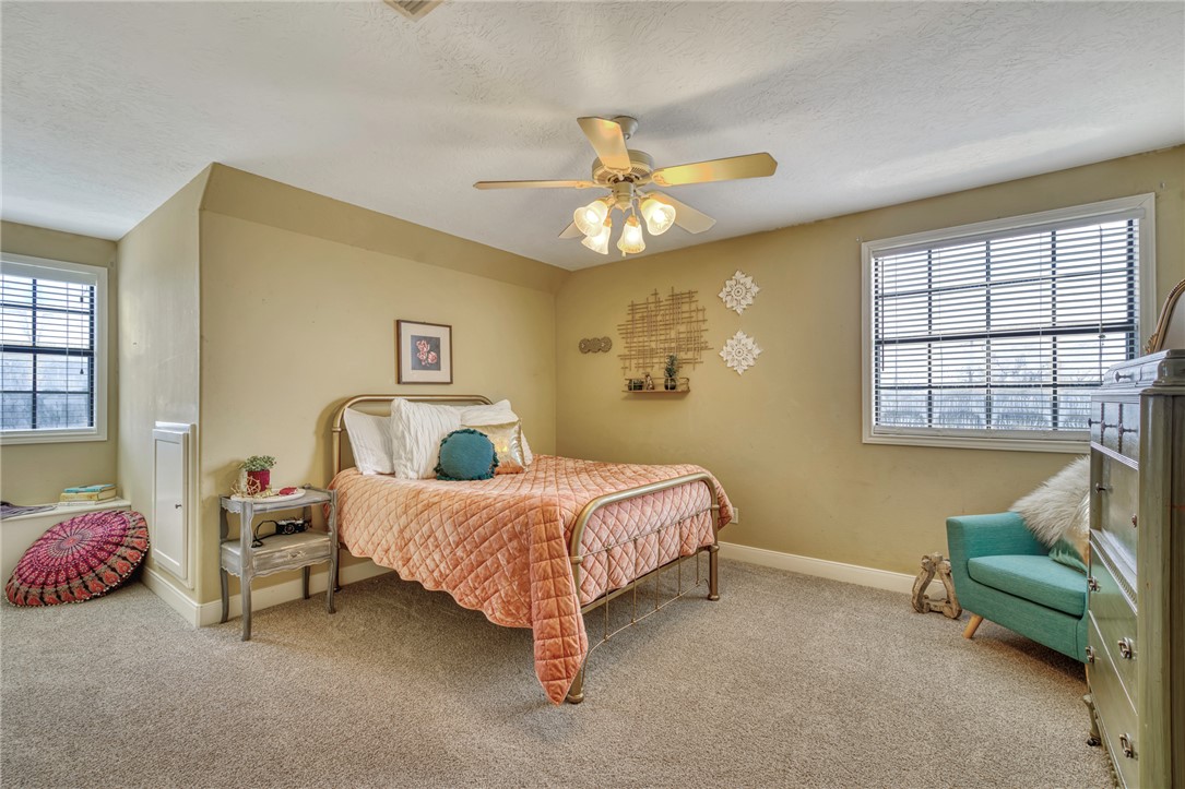 4404 County Road 151 Centerville, TX 75833 - Photo 24 of 48 a bedroom with a bed and a chandelier