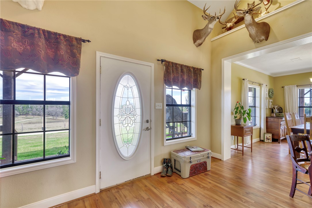 4404 County Road 151 Centerville, TX 75833 - Photo 8 of 48 a view of a livingroom with furniture wooden floor windows and a chandelier