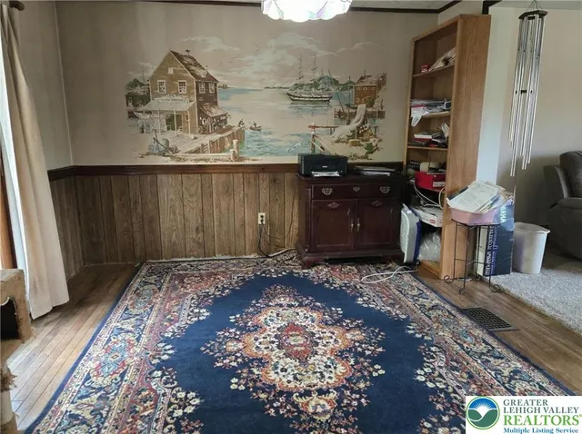 a kitchen with stainless steel appliances granite countertop a refrigerator a sink dishwasher a stove and a dining table