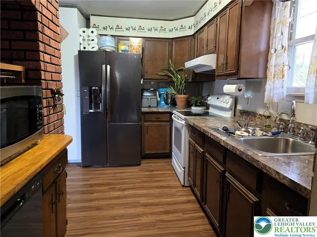 a kitchen with a sink stove and cabinets