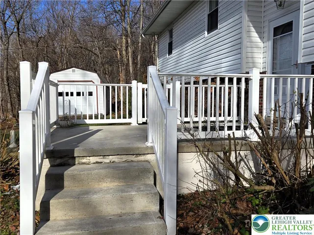 a view of a balcony with two chairs