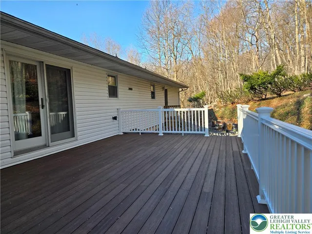 a view of deck with wooden floor and fence