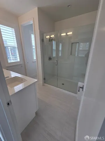 a bathroom with a sink a shower and a mirror