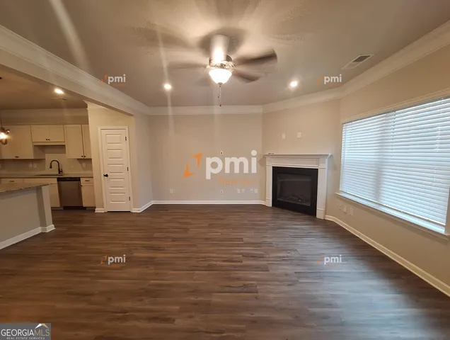 a view of an empty room with a fireplace and a window