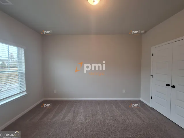 a view of an empty room and a window