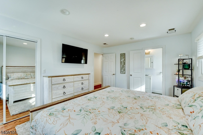 6 Elm Avenue Warren, NJ 07059 - Photo 12 of 29 a bedroom with a bed and a flat screen tv in it