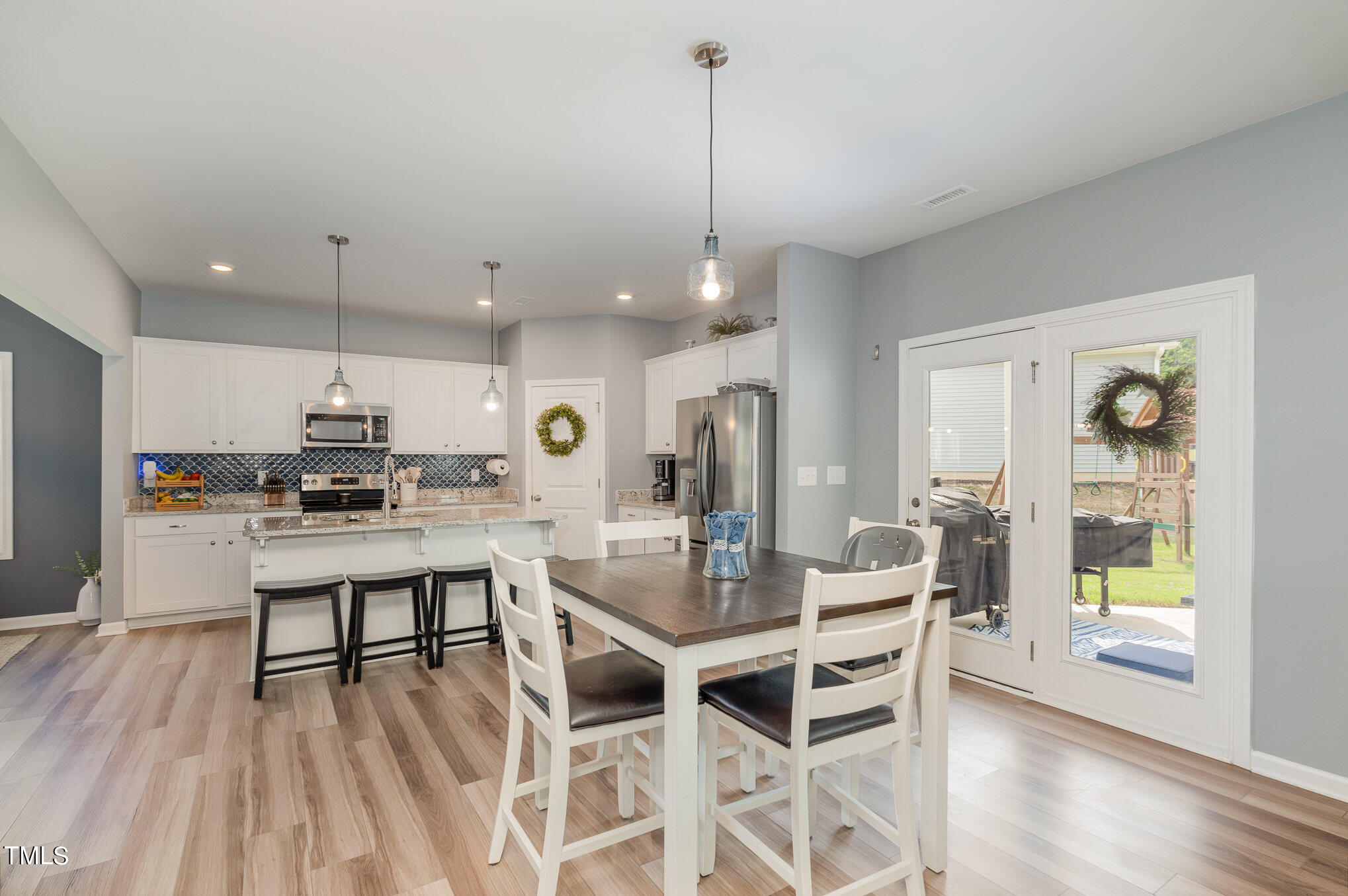 15 New Spring Way Franklinton, NC 27525 - Photo 10 of 41 a dining room with wooden floor a chandelier a wooden table and chairs