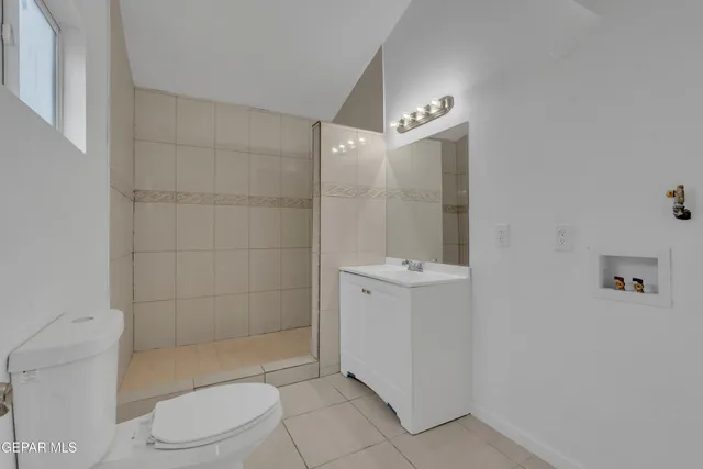 a bathroom with a toilet a sink and shower