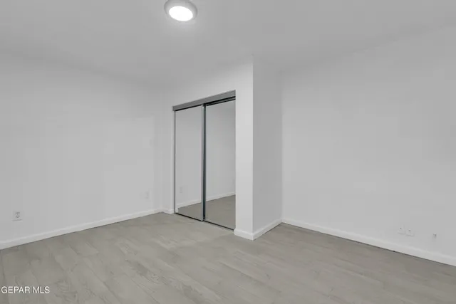 a view of an empty room and closet area