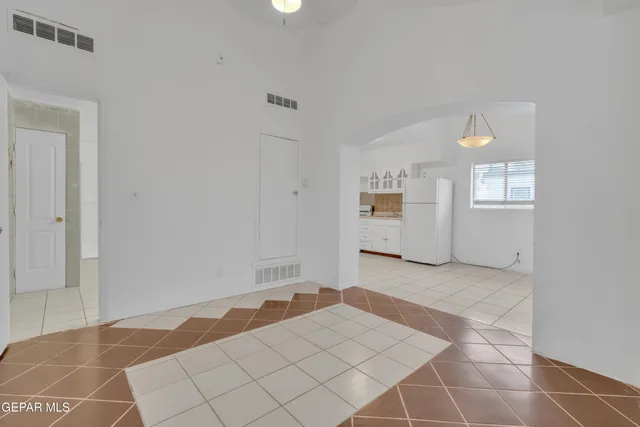 a view of a bedroom with wooden floor and windows