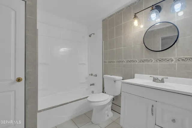 a bathroom with a toilet a sink and a mirror