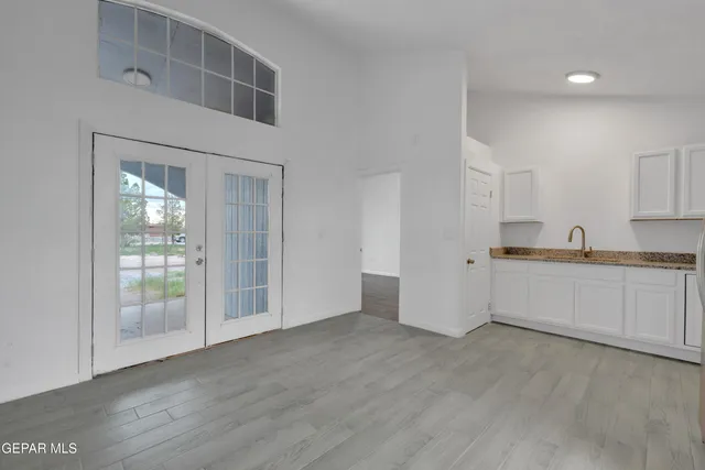 a view of a kitchen with wooden floor and a sink