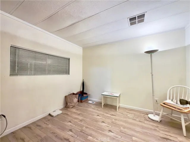 a view of a hallway with wooden floor and closet