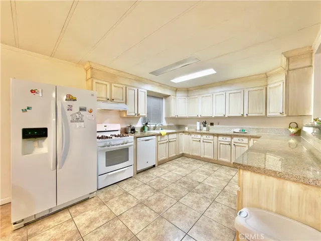 a dining room with a wooden table and chairs