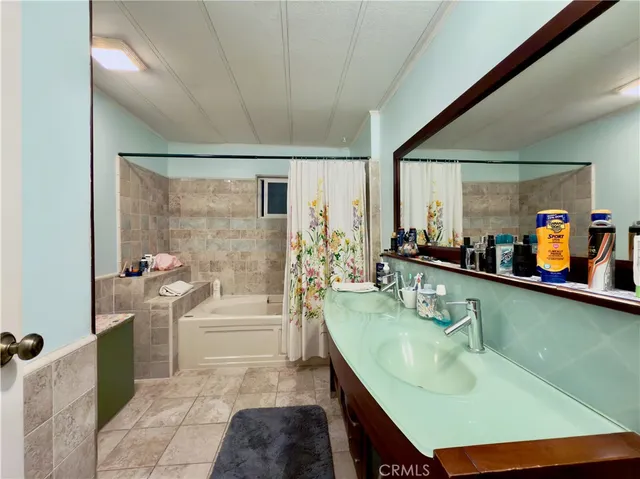 a spacious bathroom with a bathtub and sink