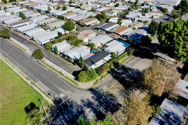 an aerial view of a house with a yard