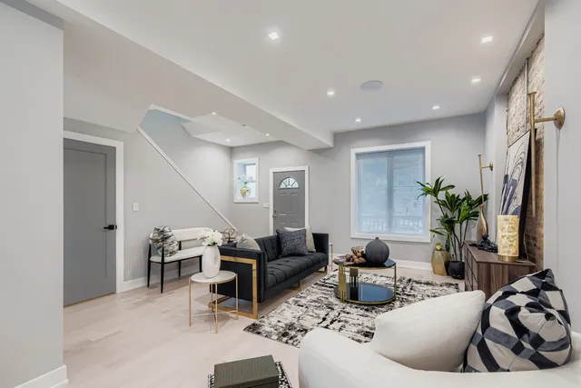 a living room with furniture potted plant and a window
