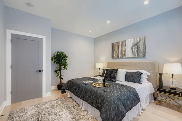 a bedroom with a bed and a potted plant