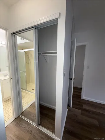a view of a hallway with wooden floor and entryway