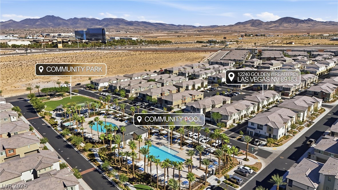 12240 Golden Wreath Road, Unit 2 Las Vegas, NV 89183 - Photo 26 of 29 Aerial view highlights the community pool and park areas set against a desert mountain backdrop.