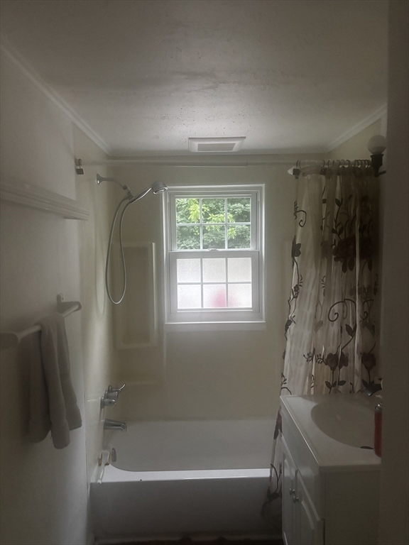 36 O Connell Street Springfield, MA 01104 - Photo 10 of 14 a white bath tub sitting next to a shower
