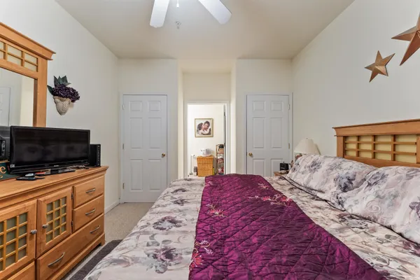a bedroom with a bed and a flat screen tv