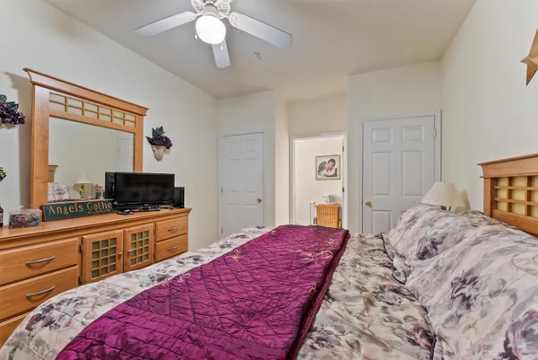a bedroom with a large bed and a flat screen tv