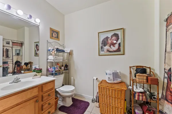 a bathroom with a toilet a sink and mirror