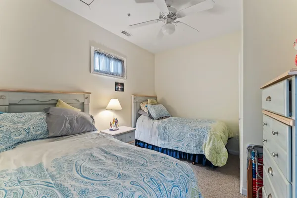 a bedroom with a bed and ceiling fan