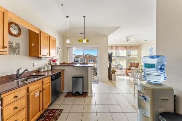 a kitchen with granite countertop a sink a counter space appliances and cabinets