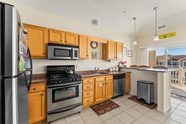 a kitchen with a stove a sink and a microwave