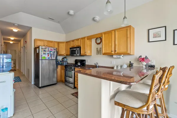 a kitchen with refrigerator and cabinets