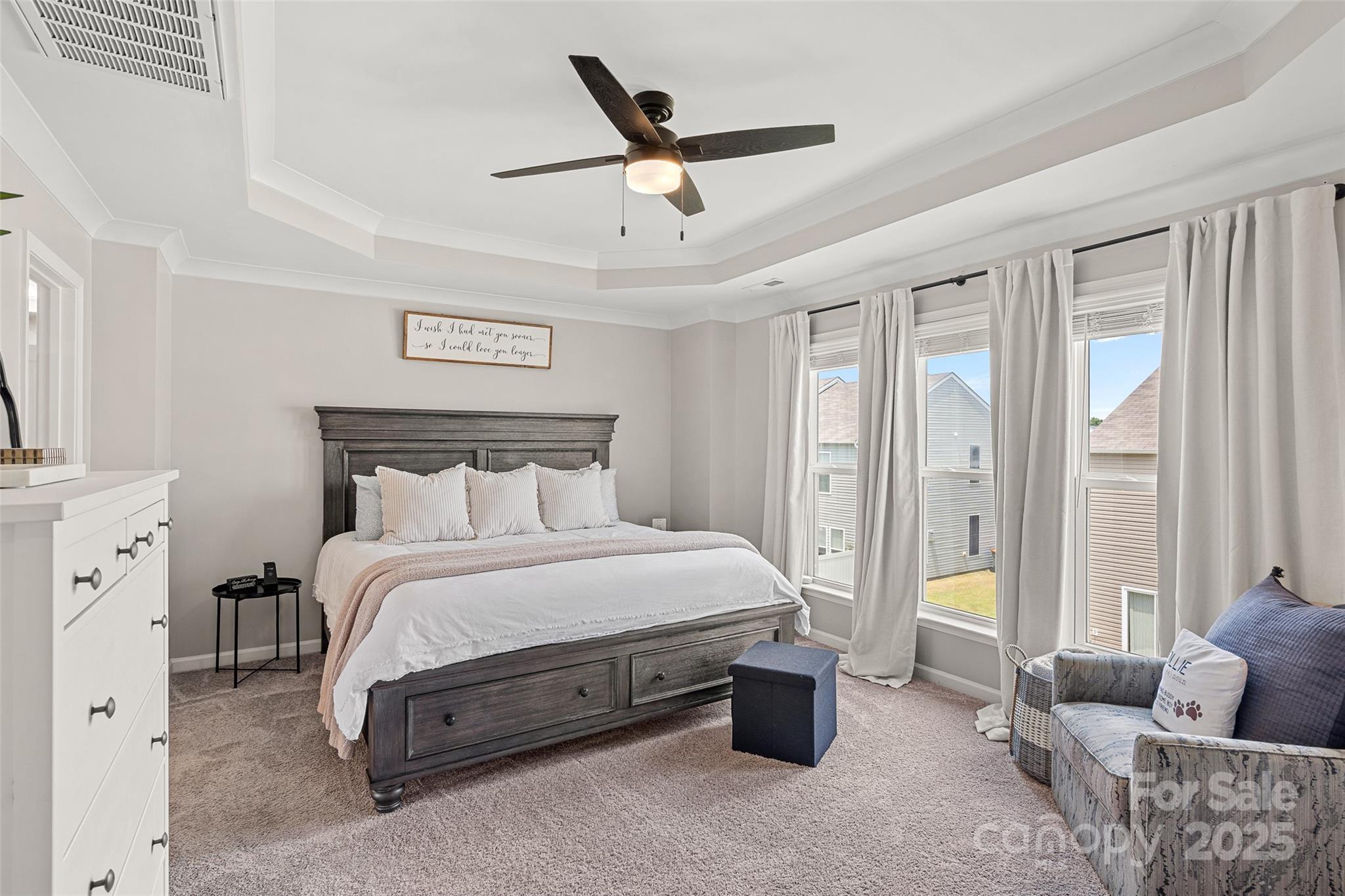 816 Canoe Song Road Fort Mill, SC 29708 - Photo 11 of 26 a spacious bedroom with a bed a couch and a ceiling fan