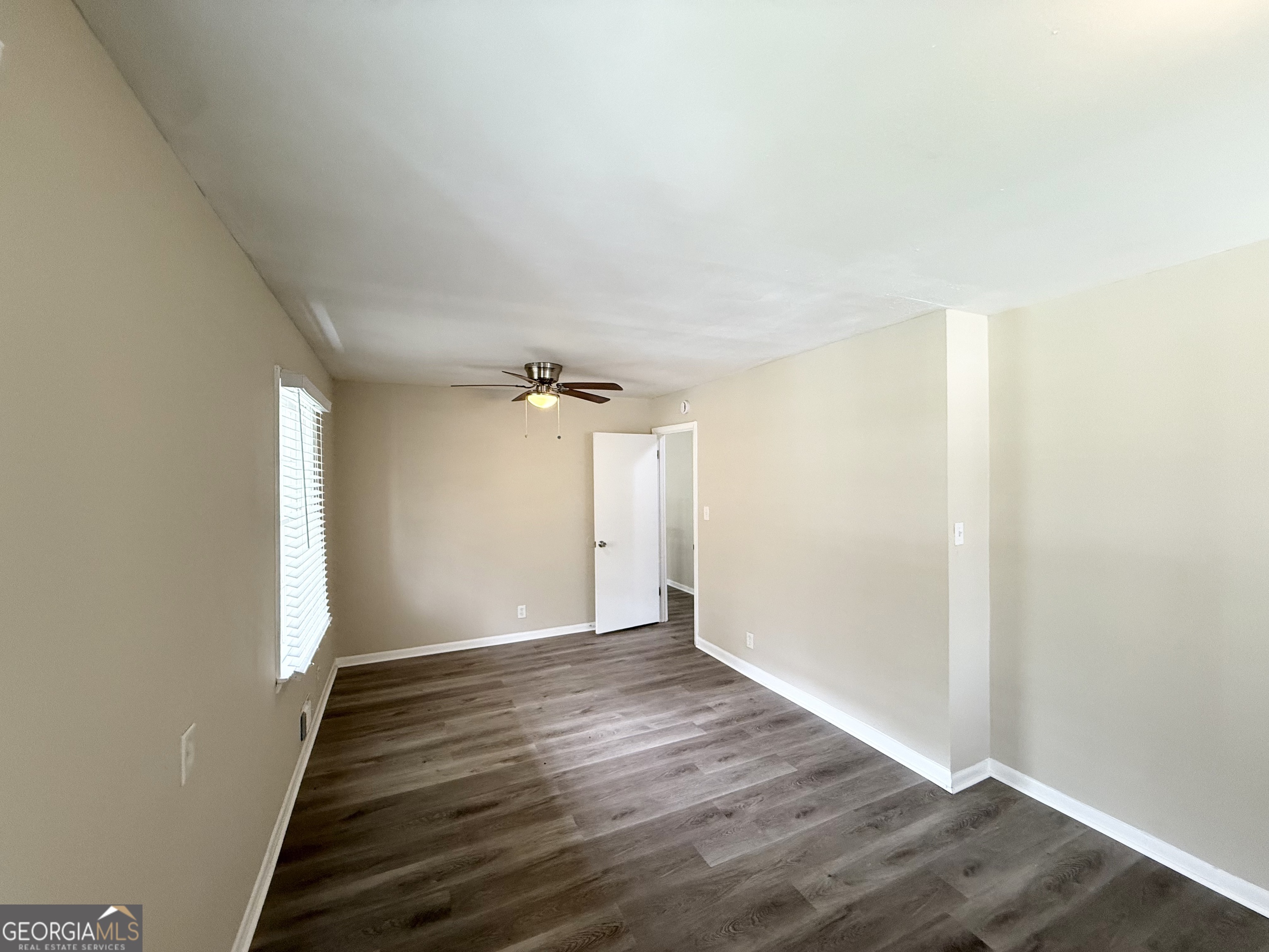2782 Ocean Valley Road Atlanta, GA 30349 - Photo 12 of 27 an empty room with wooden floor and windows