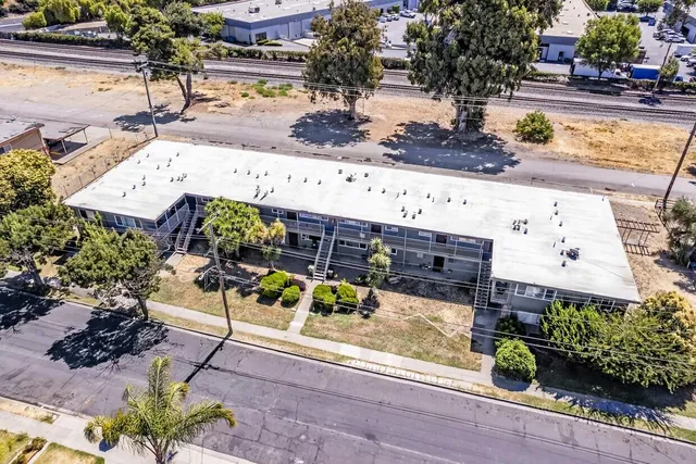 an aerial view of a swimming pool with outdoor seating