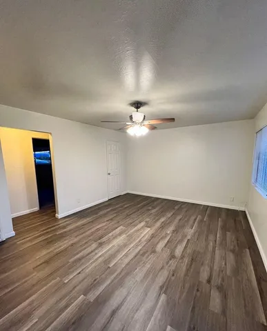 a kitchen with a white cabinets and wooden floor
