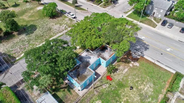an aerial view of a house with a yard and garden
