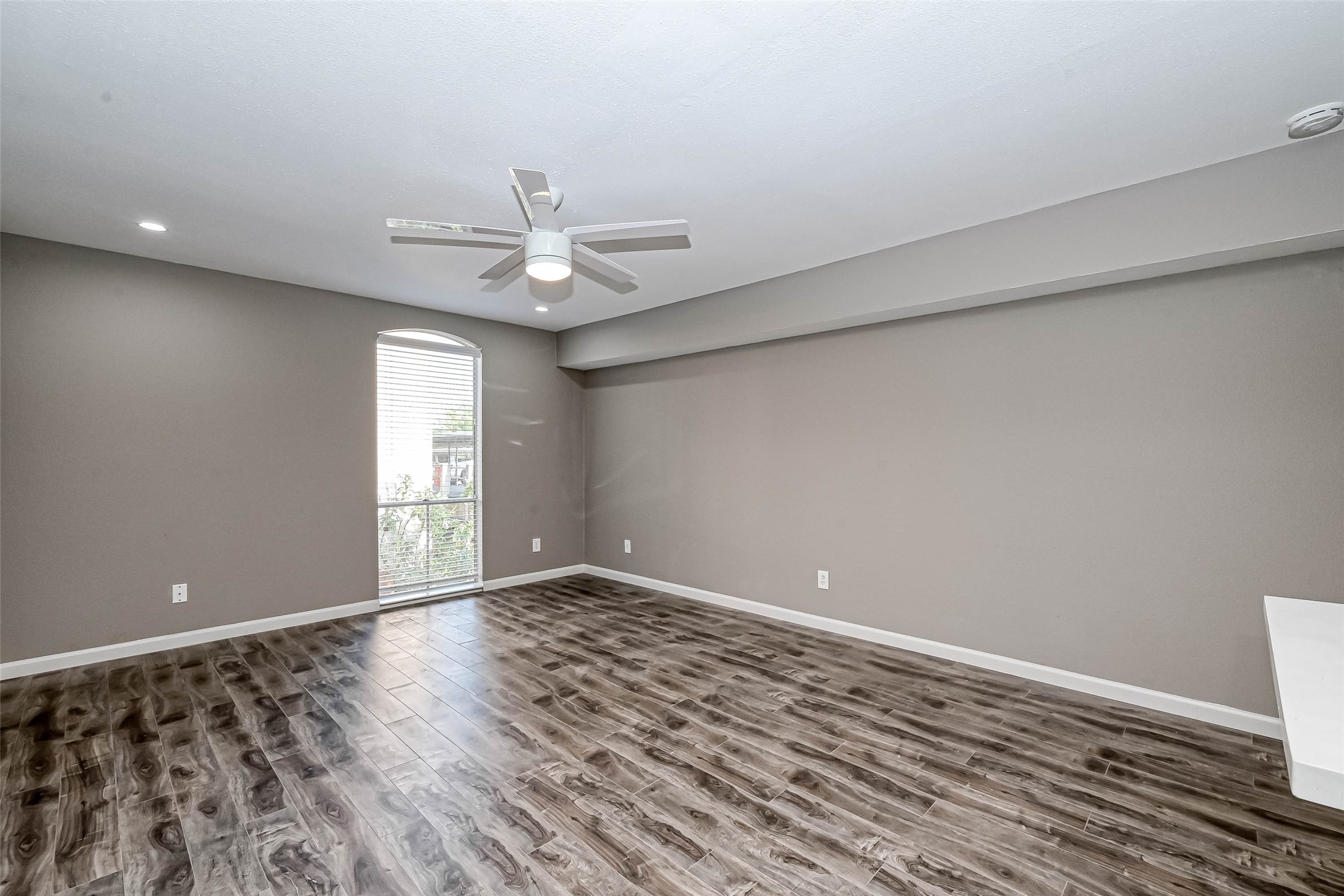 4645 Wild Indigo Street, Unit 375 Houston, TX 77027 - Photo 11 of 27 wooden floor in an empty room with a window