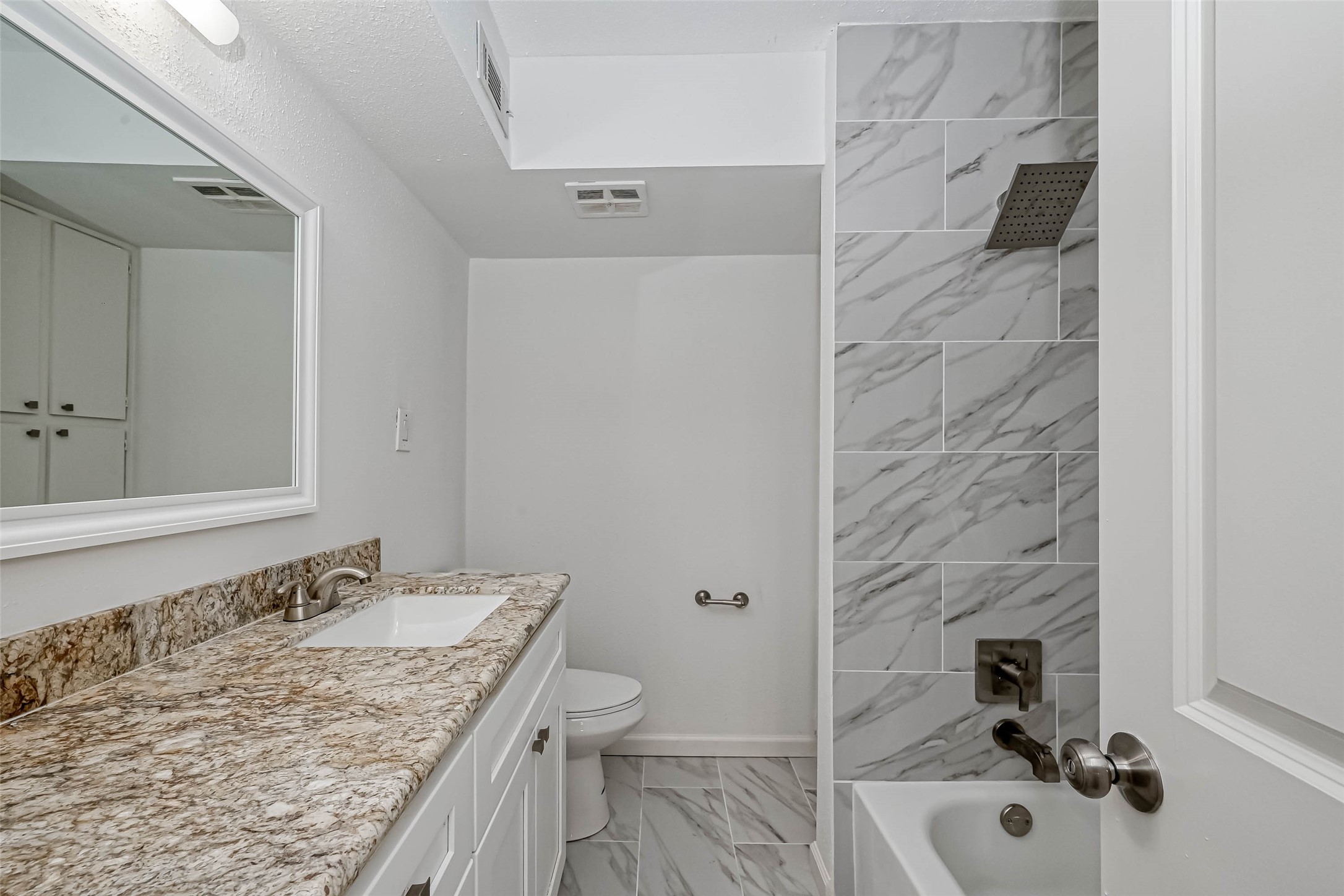 4645 Wild Indigo Street, Unit 375 Houston, TX 77027 - Photo 15 of 27 a bathroom with a granite countertop sink a toilet and shower