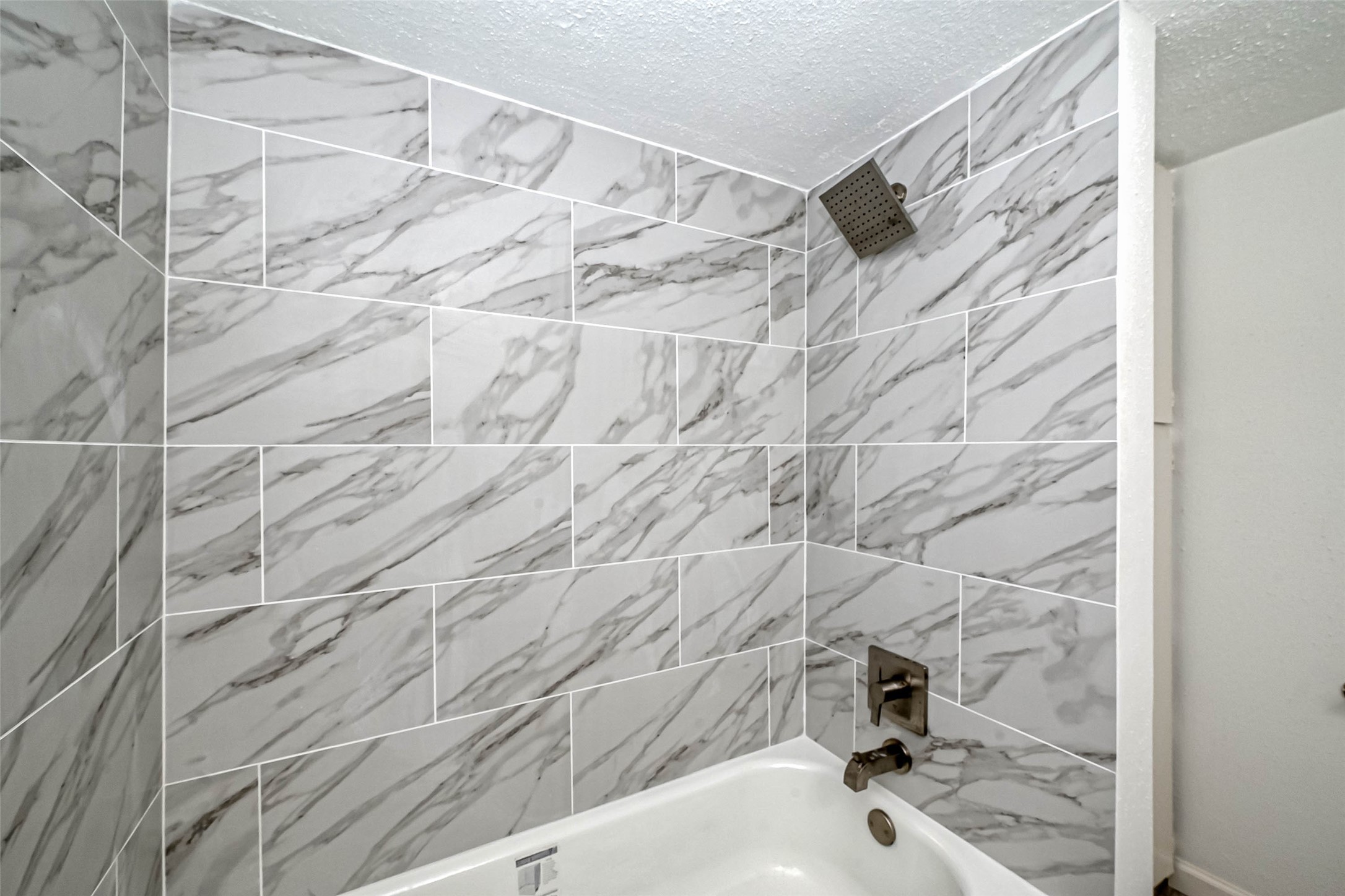 4645 Wild Indigo Street, Unit 375 Houston, TX 77027 - Photo 20 of 27 a bathroom with a bathtub and a shower