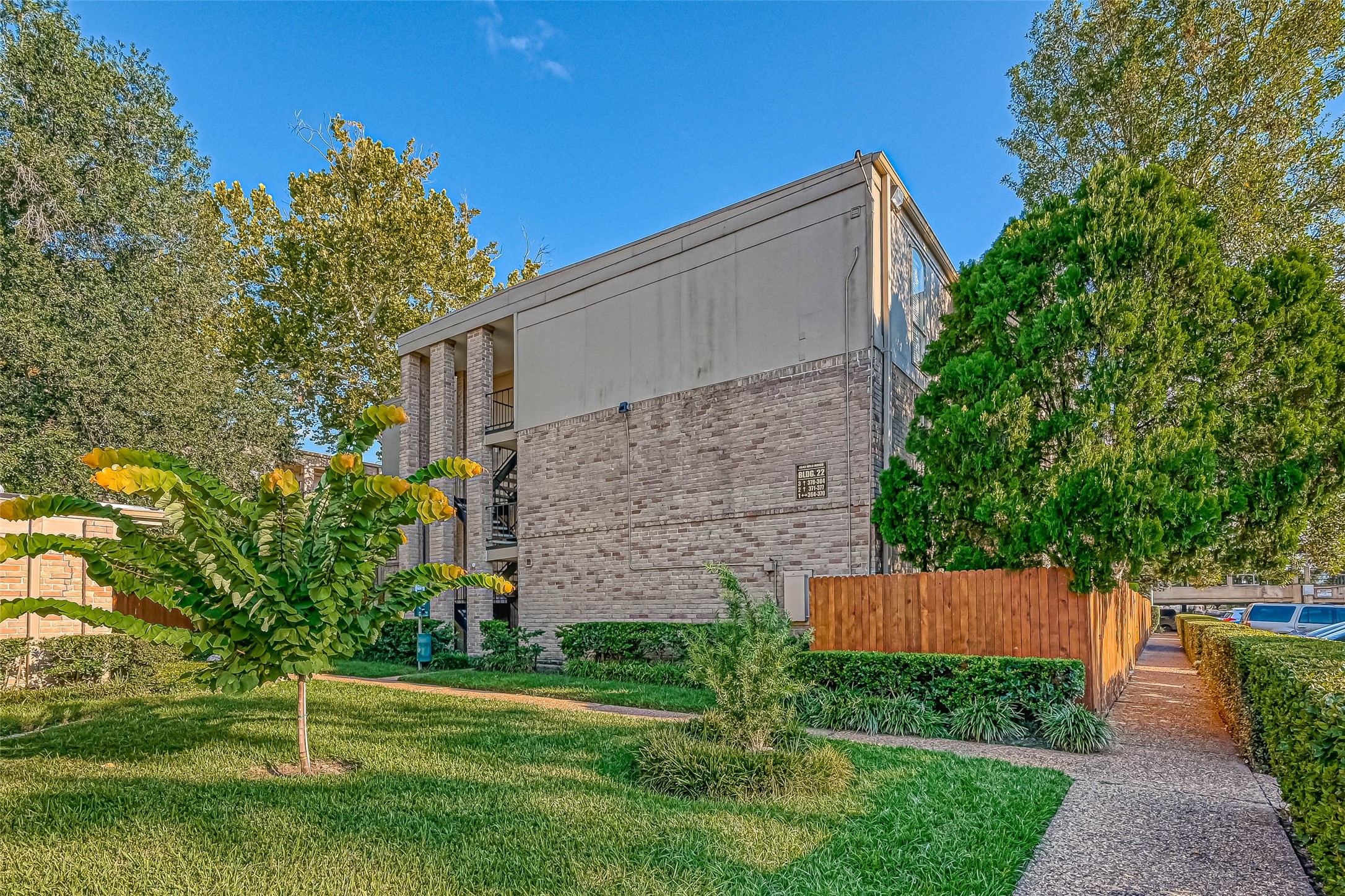 4645 Wild Indigo Street, Unit 375 Houston, TX 77027 - Photo 26 of 27 a view of a house with a yard