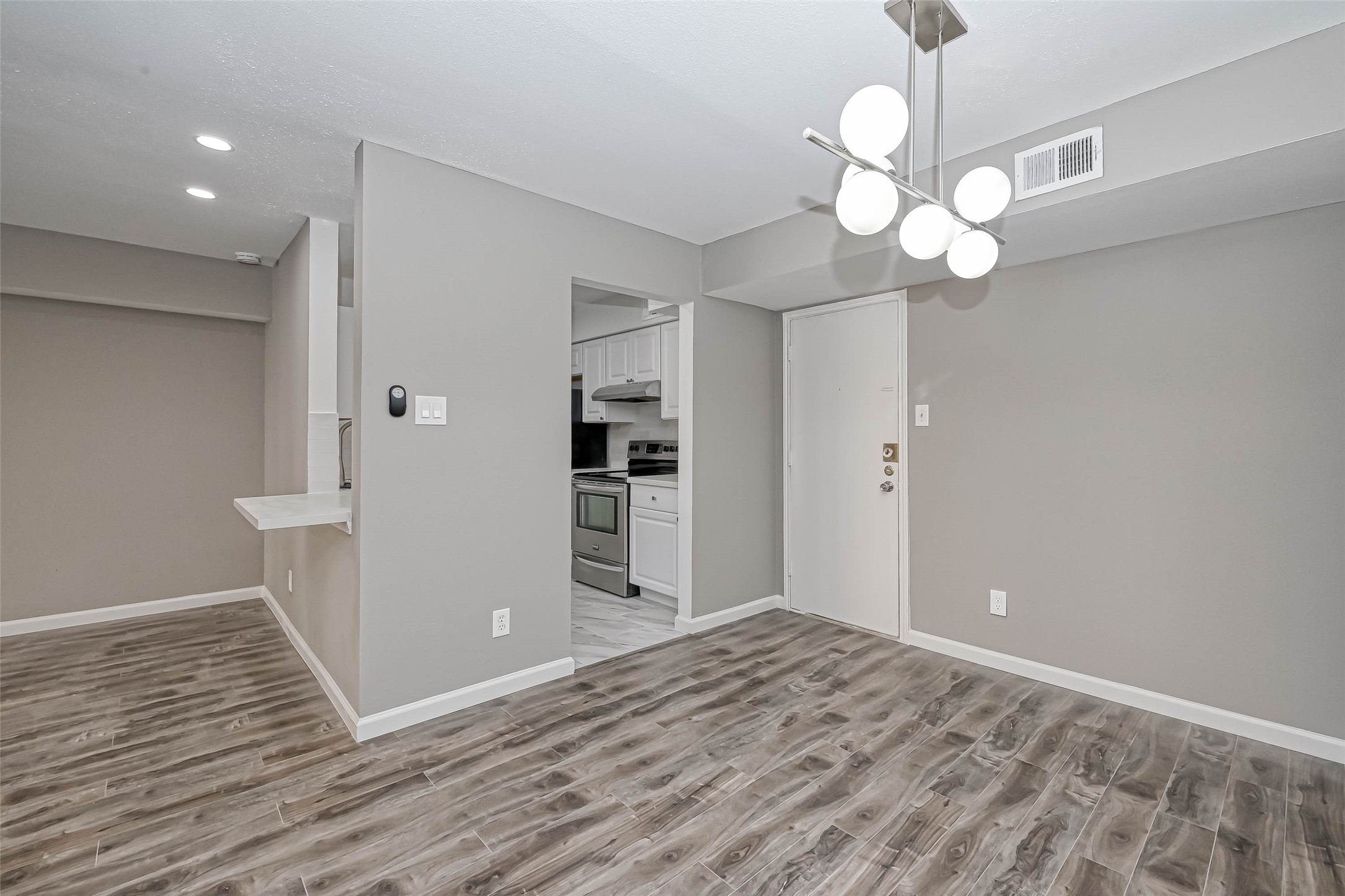 4645 Wild Indigo Street, Unit 375 Houston, TX 77027 - Photo 10 of 27 wooden floor in an empty room with a window