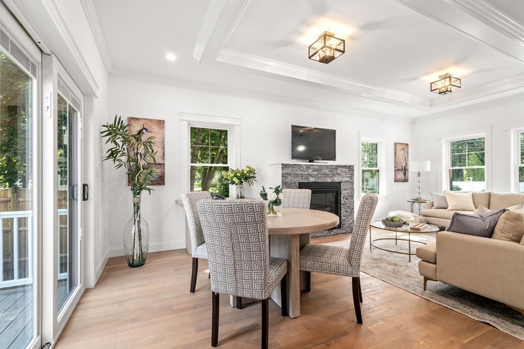 504 Hudson Road Sudbury, MA 01776 - Photo 12 of 42 a living room with furniture a fireplace and a flat screen tv