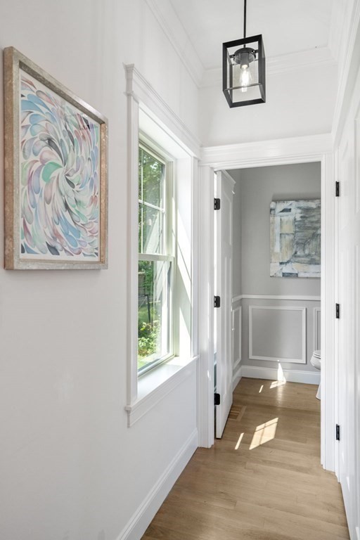 504 Hudson Road Sudbury, MA 01776 - Photo 20 of 42 a view of a hallway with wooden floor and a workspace
