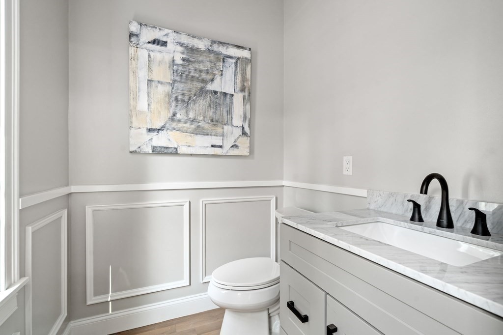 504 Hudson Road Sudbury, MA 01776 - Photo 21 of 42 a bathroom with a toilet sink and mirror